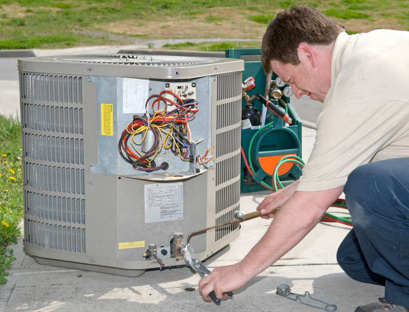 Technician replacing an AC unit