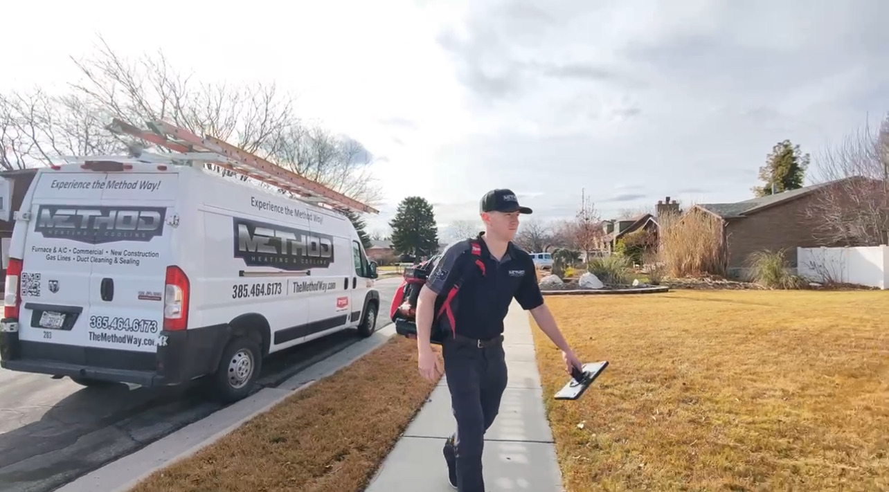 HVAC technician performing an AC tune up in Lehi, UT