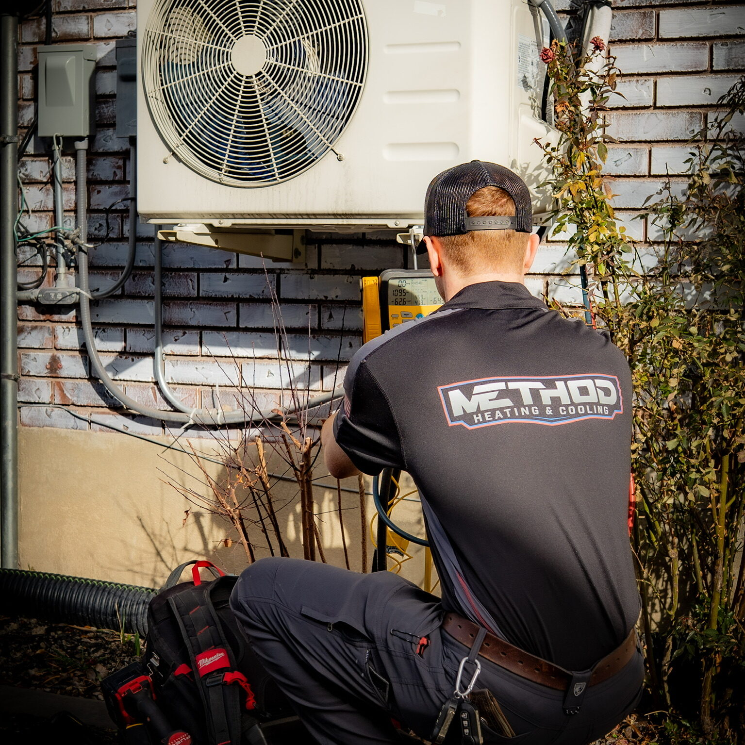 HVAC technician cleaning AC coils in Herriman, UT
