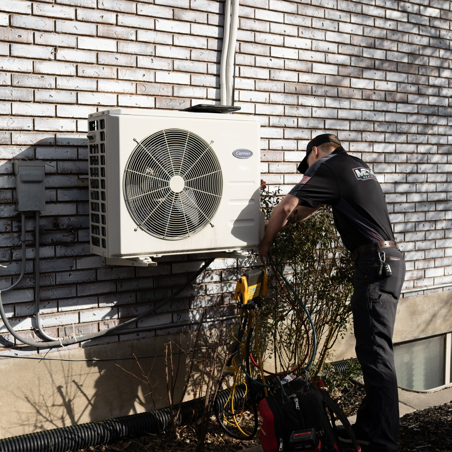 HVAC technician performing professional AC tune up in Sandy UT