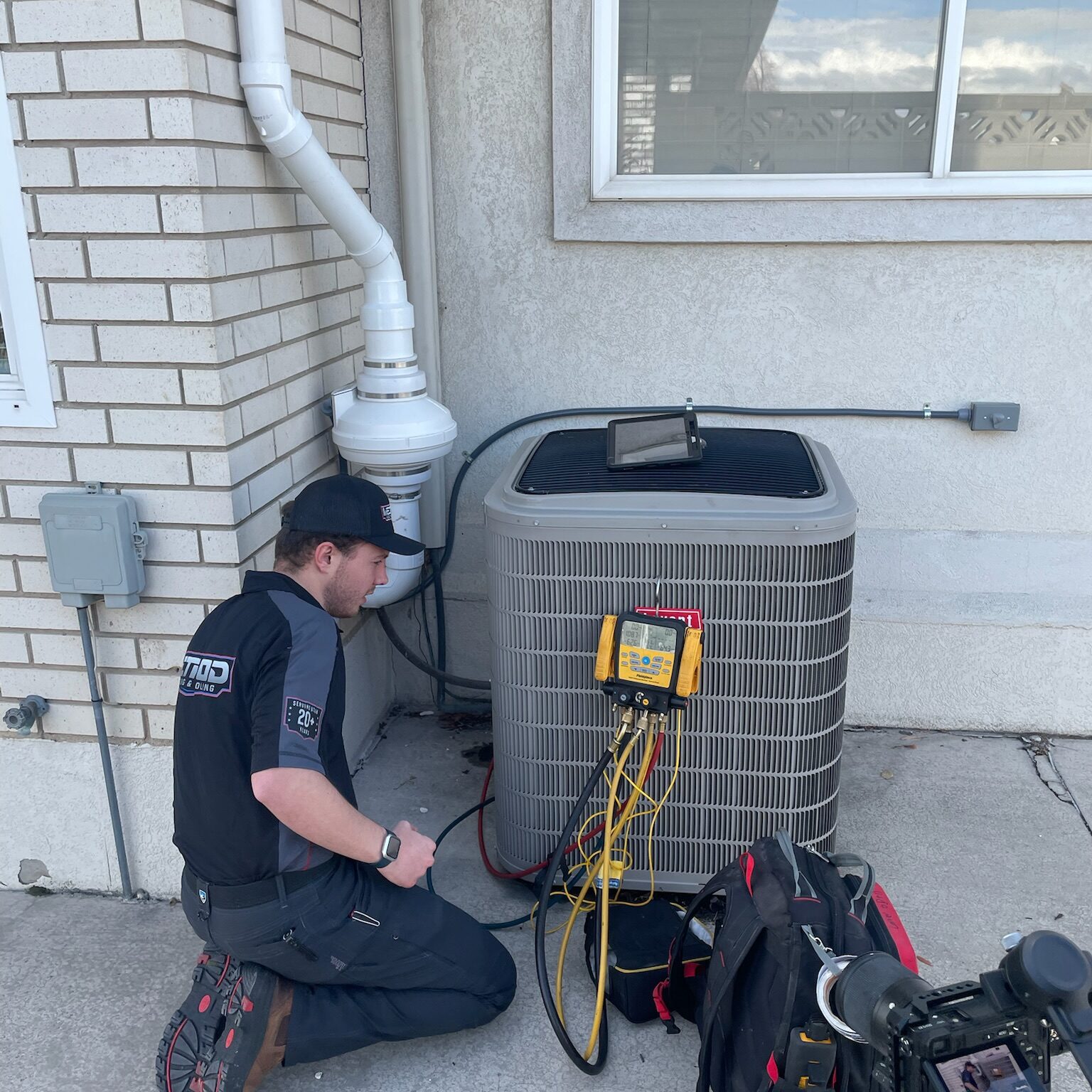 HVAC technician performing an AC tune up in Saratoga Springs, UT