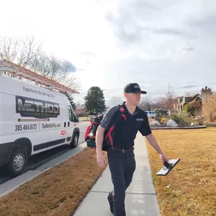 HVAC technician performing an AC tune up in Lehi, UT